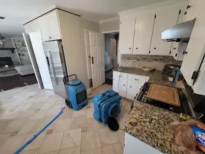 Kitchen with a dehumidifier and air mover running after a leak in Brentwood, TN
