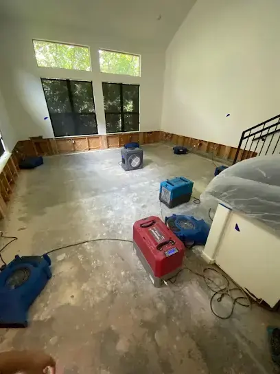 Room with flood-cut walls and drying equipment on the floor in Brentwood, TN