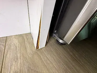 Appliance pulled out from its cabinet over a wet plank floor in Brentwood, TN