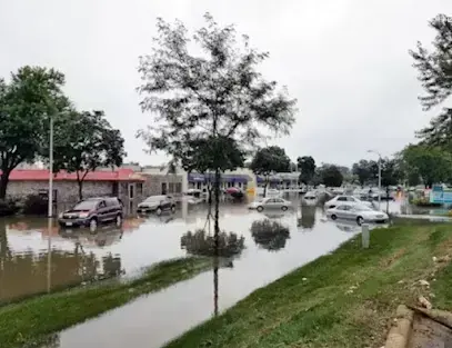Flood water over a parking lot and lawn after heavy rain near Brentwood, TN