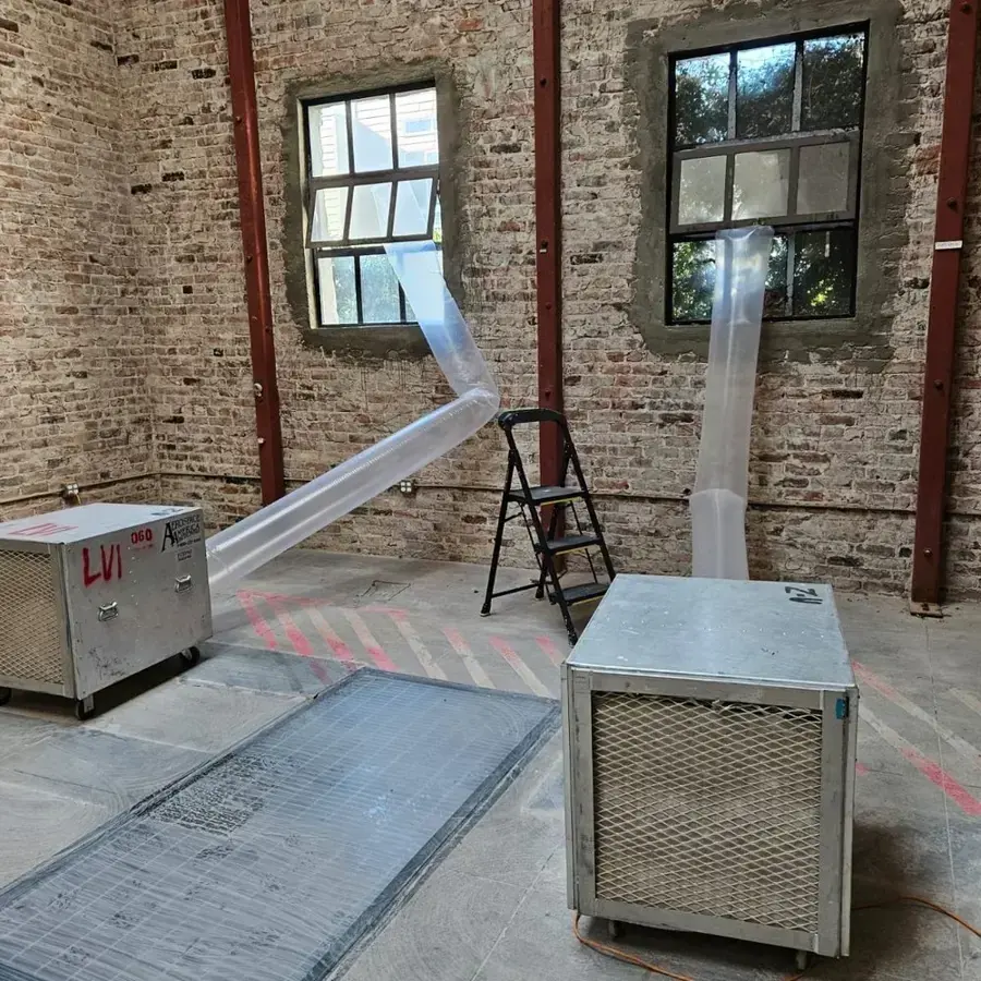 Dehumidifiers ducting dry air through a brick-walled room in Brentwood, TN