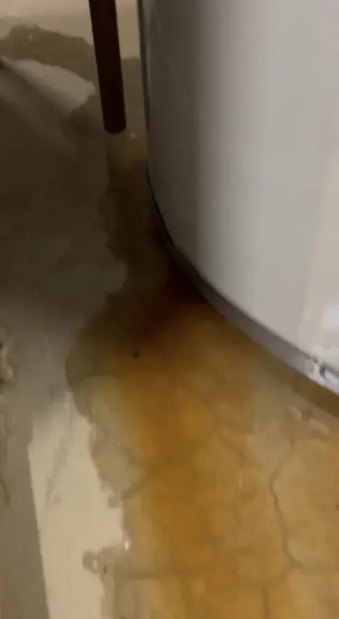 Rust-colored water pooling at the base of a water heater in Brentwood, TN
